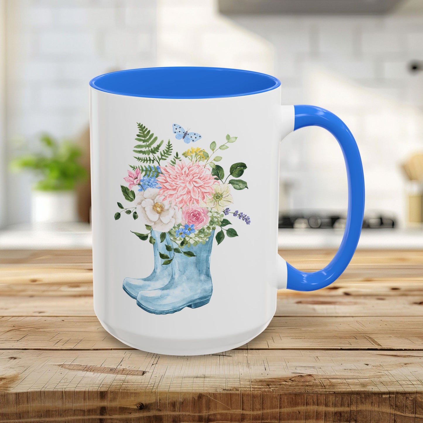 15oz glossy ceramic mug with a blue handle and interior, featuring a watercolor rain boot with a floral bouquet.