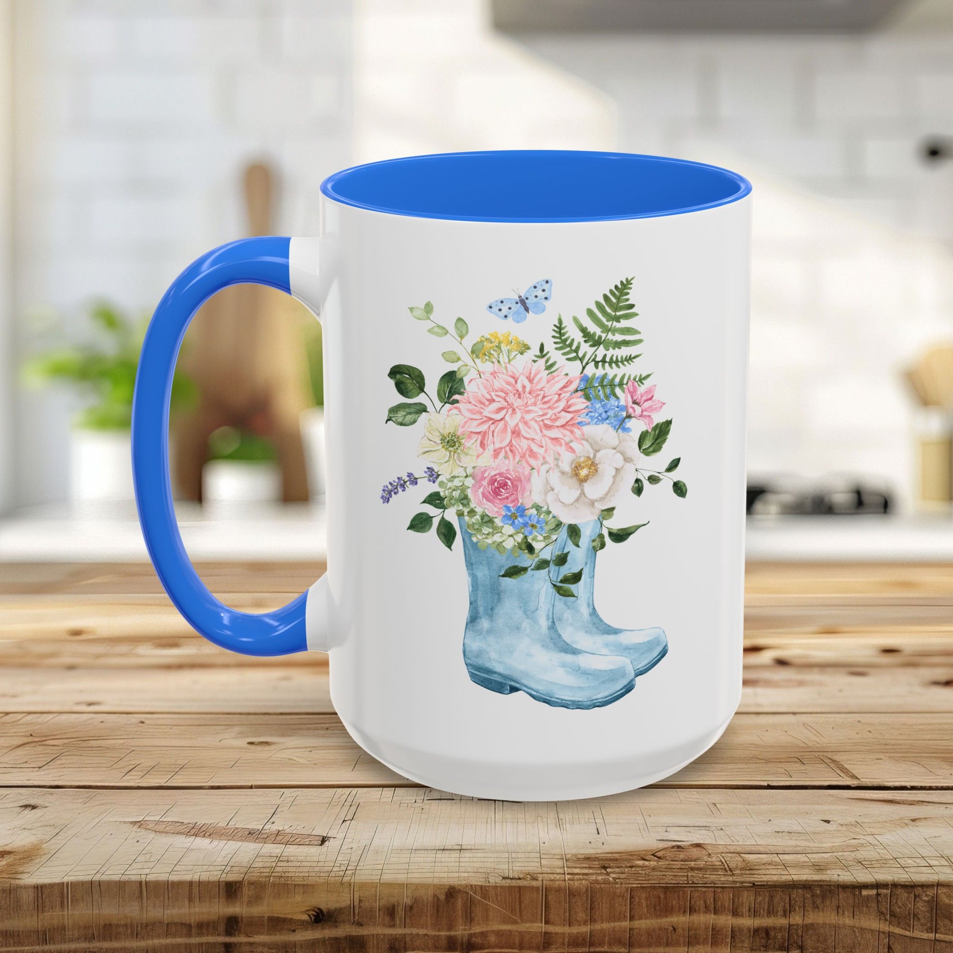 White ceramic mug with blue handle and interior, featuring a watercolor rain boot with a floral bouquet.