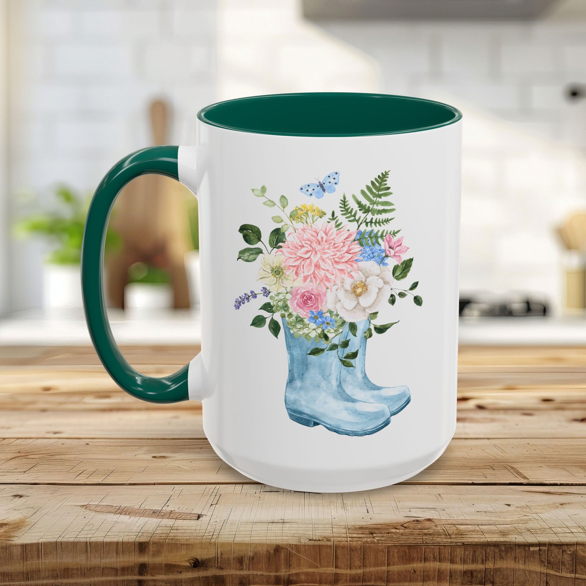White ceramic mug with a green handle and interior, featuring a watercolor rain boot filled with flowers.