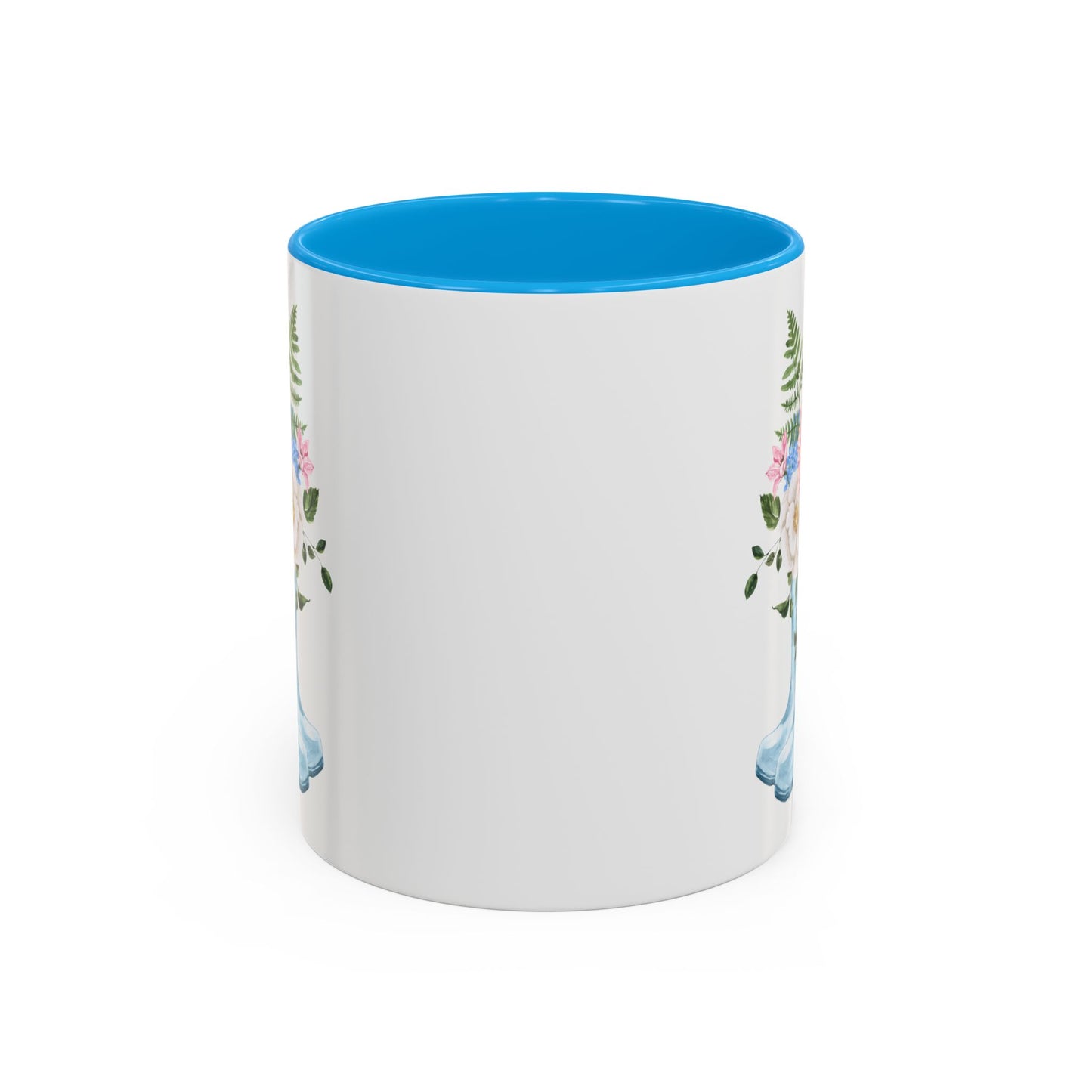 White ceramic mug with blue interior and handle, featuring a watercolor rain boot and floral bouquet design.