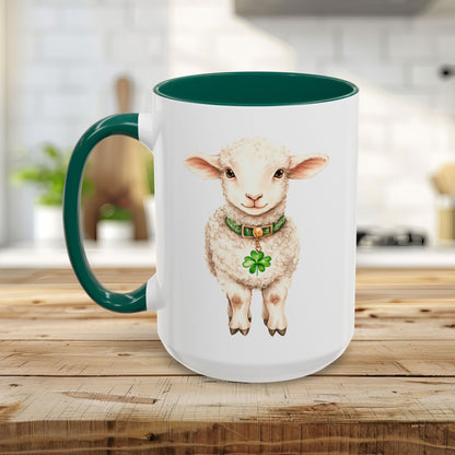 White ceramic mug with a green handle and interior, featuring a watercolor lamb with a clover pendant.