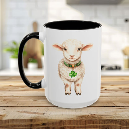 White ceramic mug with black handle and interior, featuring a watercolor lamb wearing a green clover pendant.