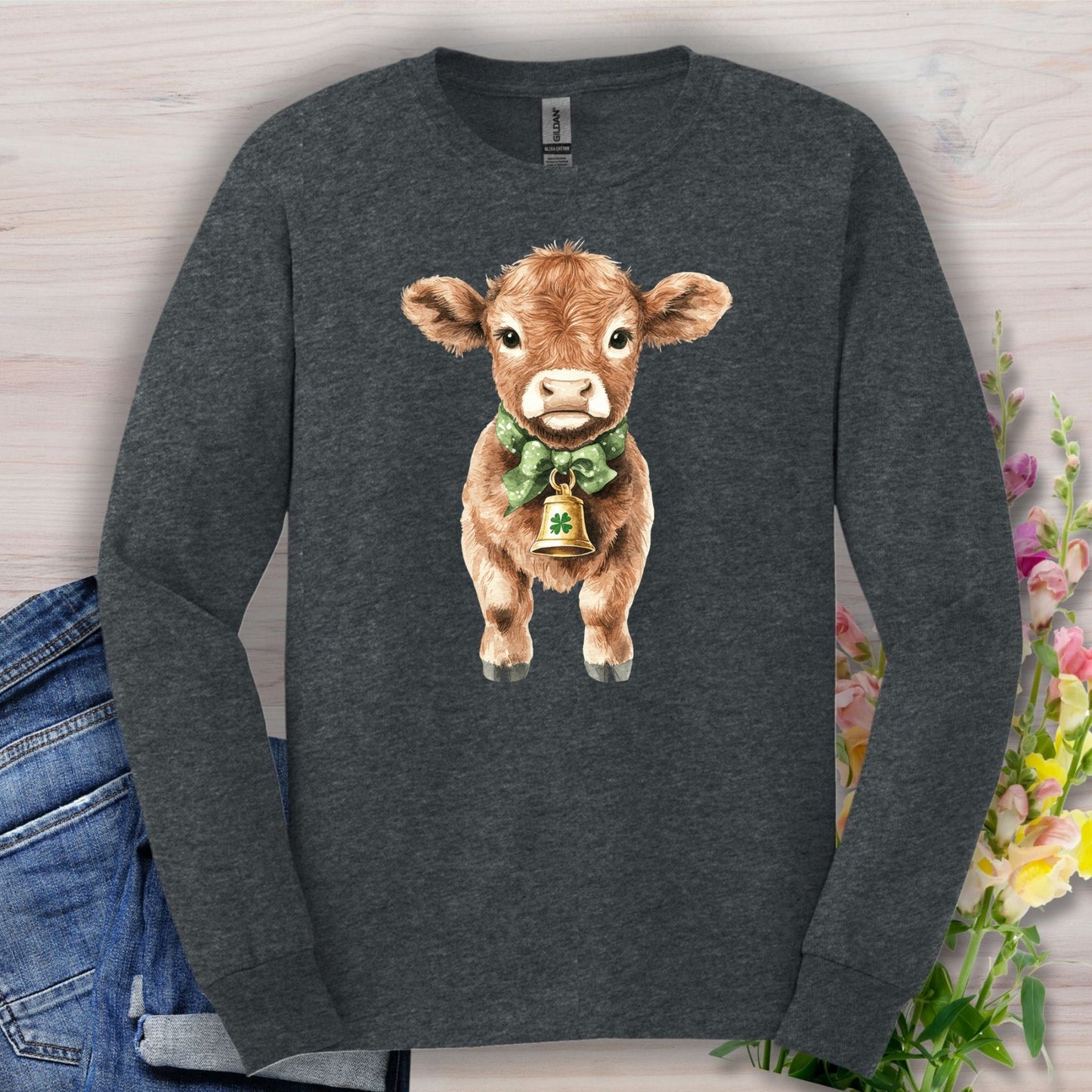 Dark Heather long sleeve tee with watercolor baby Highland cow, green bow, and clover bell.