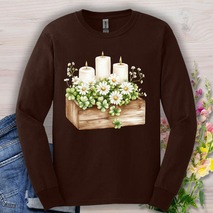 Dark Chocolate long sleeve tee with a watercolor clover planter, daisies, baby's breath, and three lit candles.