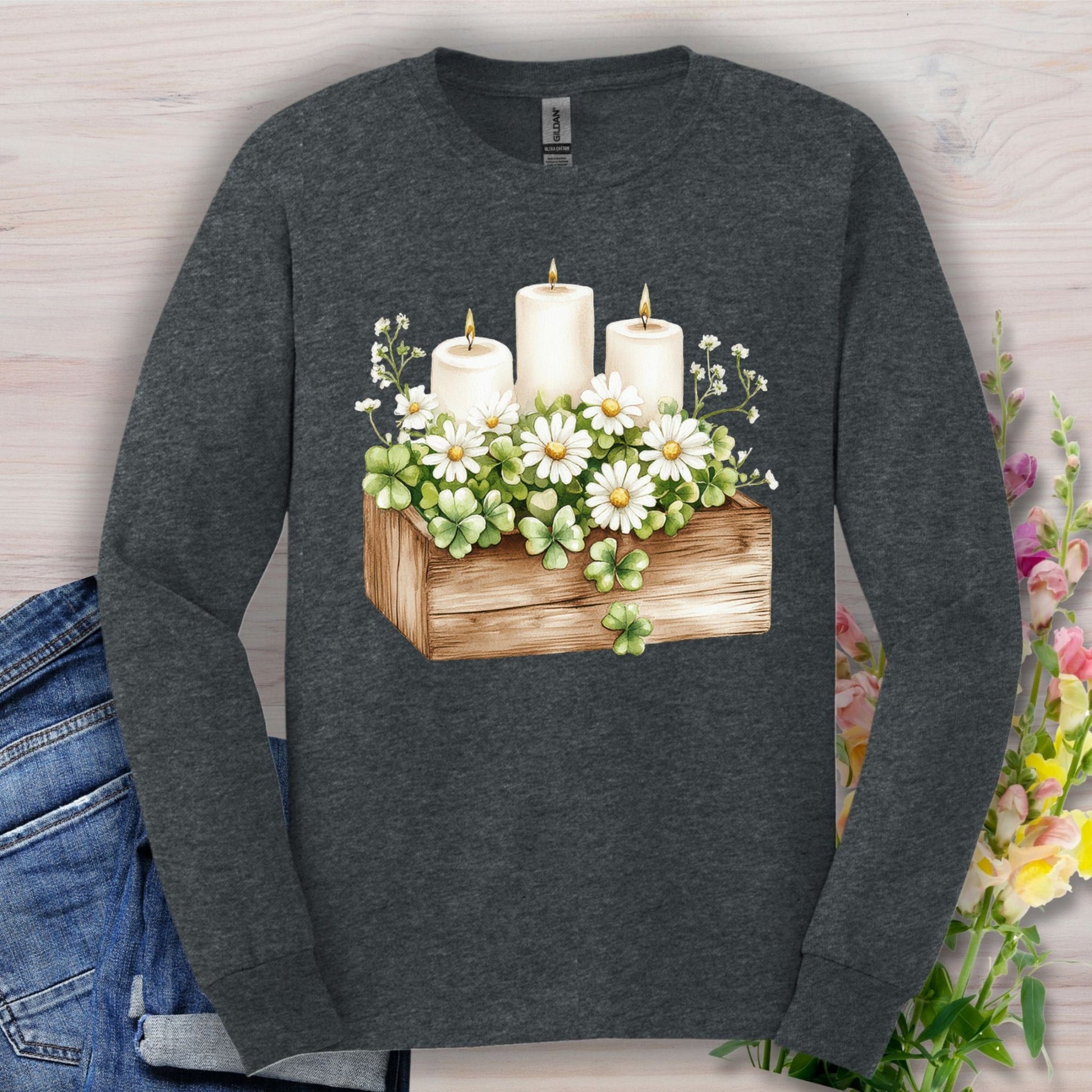 Dark Heather long sleeve tee with a watercolor wooden planter, daisies, candles, and four-leaf clovers.