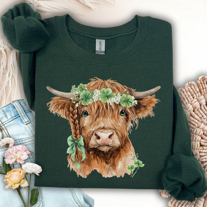 Dark green sweatshirt with watercolor Highland cow wearing clover garland and bow.