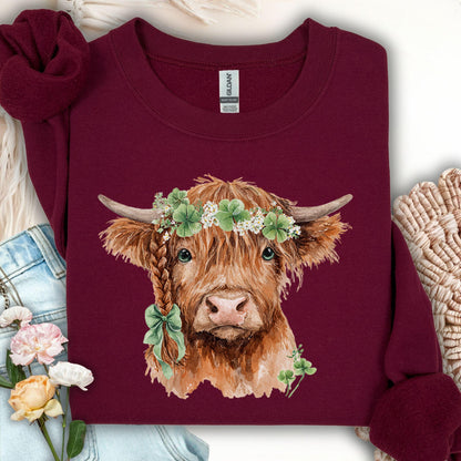 Maroon sweatshirt with watercolor Highland cow in clover garland and bow, size S.