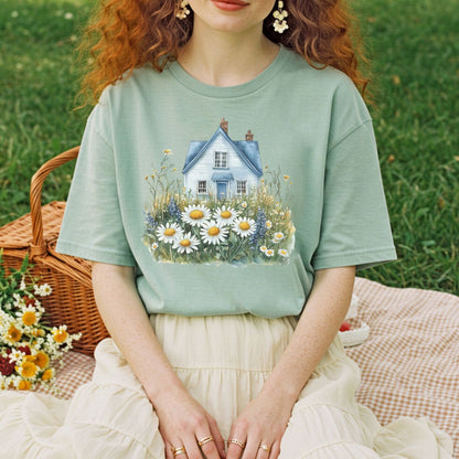 Garment-dyed sage green t-shirt with a blue cottage and wildflower field graphic.