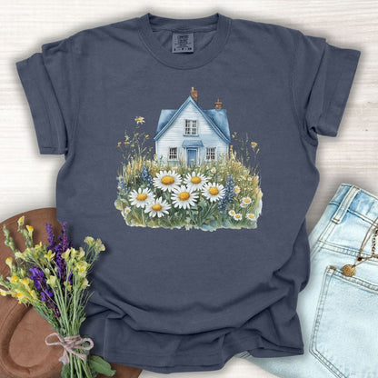 Denim blue garment-dyed cotton t-shirt with a watercolor cottage and wildflower field design.