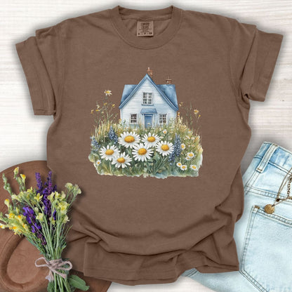 Espresso garment-dyed t-shirt with a blue cottage and wildflower field design, size S.