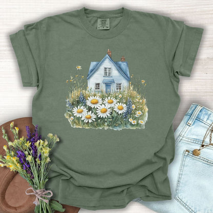 Moss green garment-dyed cotton t-shirt with a blue cottage and wildflower field graphic.