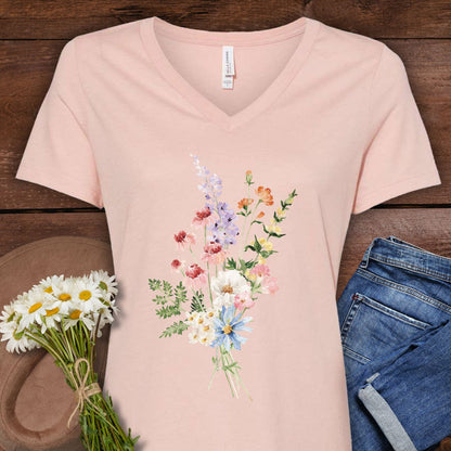 Heather Dust v-neck t-shirt with a delicate wildflower bouquet illustration, paired with jeans and daisies.