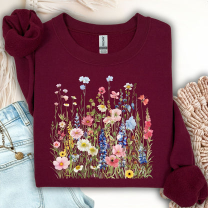 Maroon Summer Meadow sweatshirt with watercolor wildflowers, shown with jeans and a necklace.