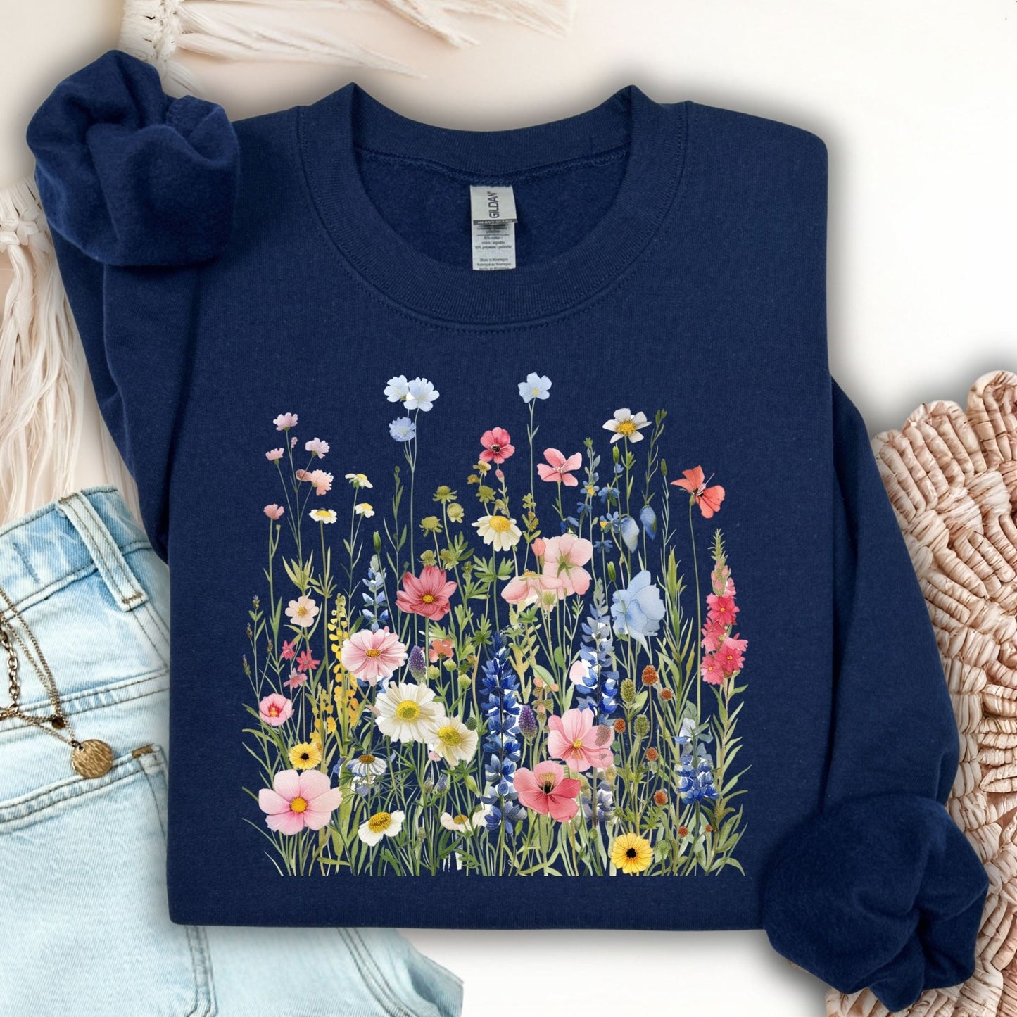 Navy Summer Meadow sweatshirt with colorful watercolor wildflowers, made from a soft cotton-blend fabric.