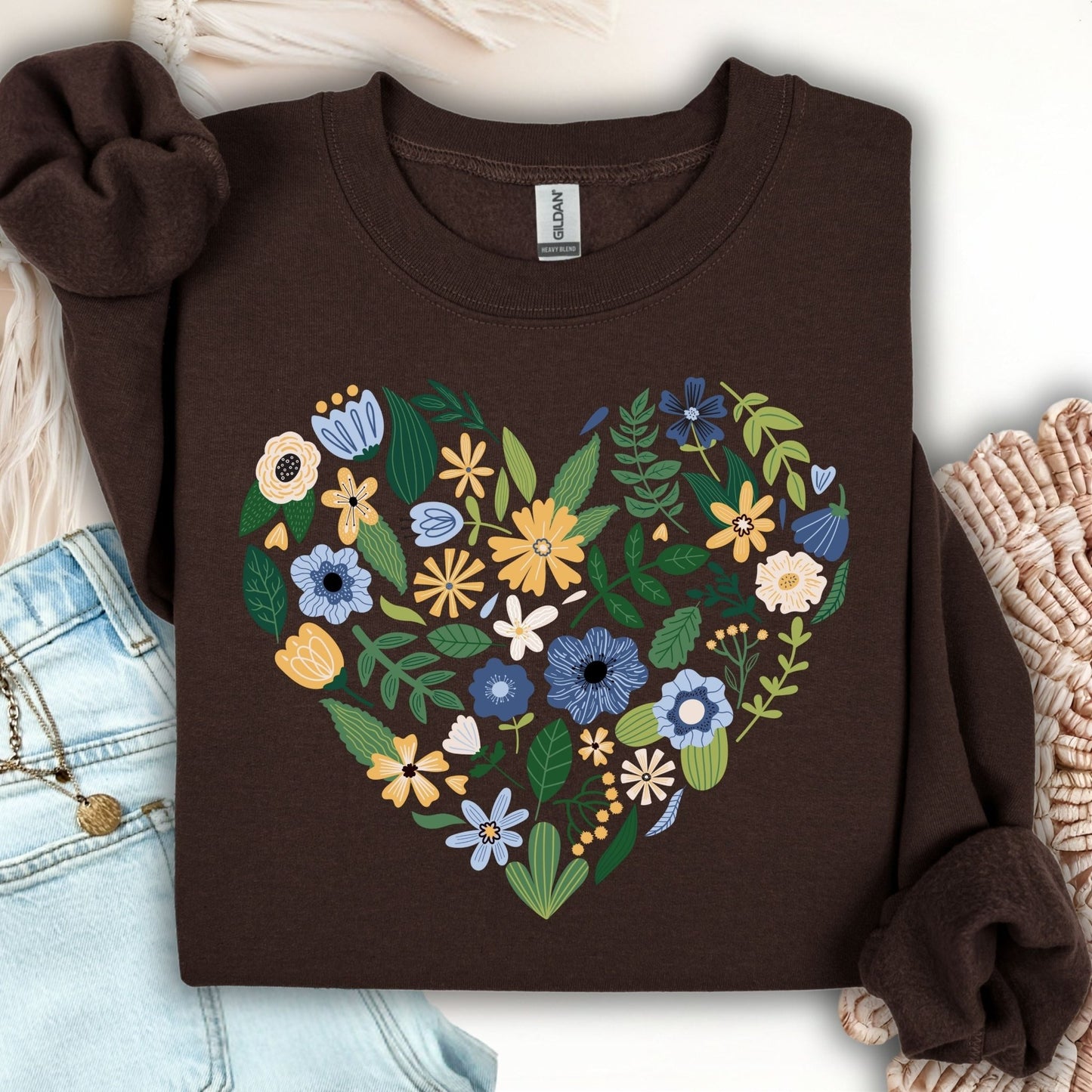 Dark chocolate sweatshirt with a large heart filled with blue, yellow, and cream floral designs.