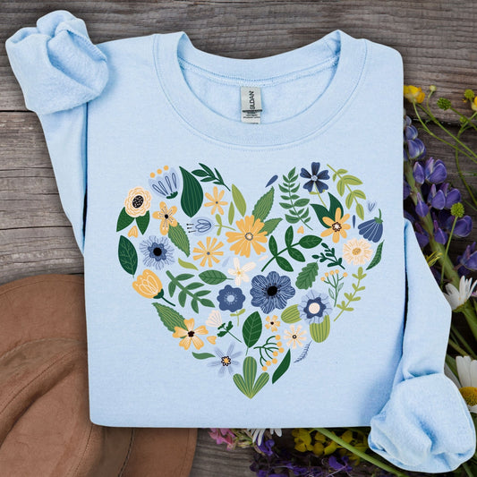 Light blue sweatshirt with a heart design made of blue, yellow, and cream floral blooms.