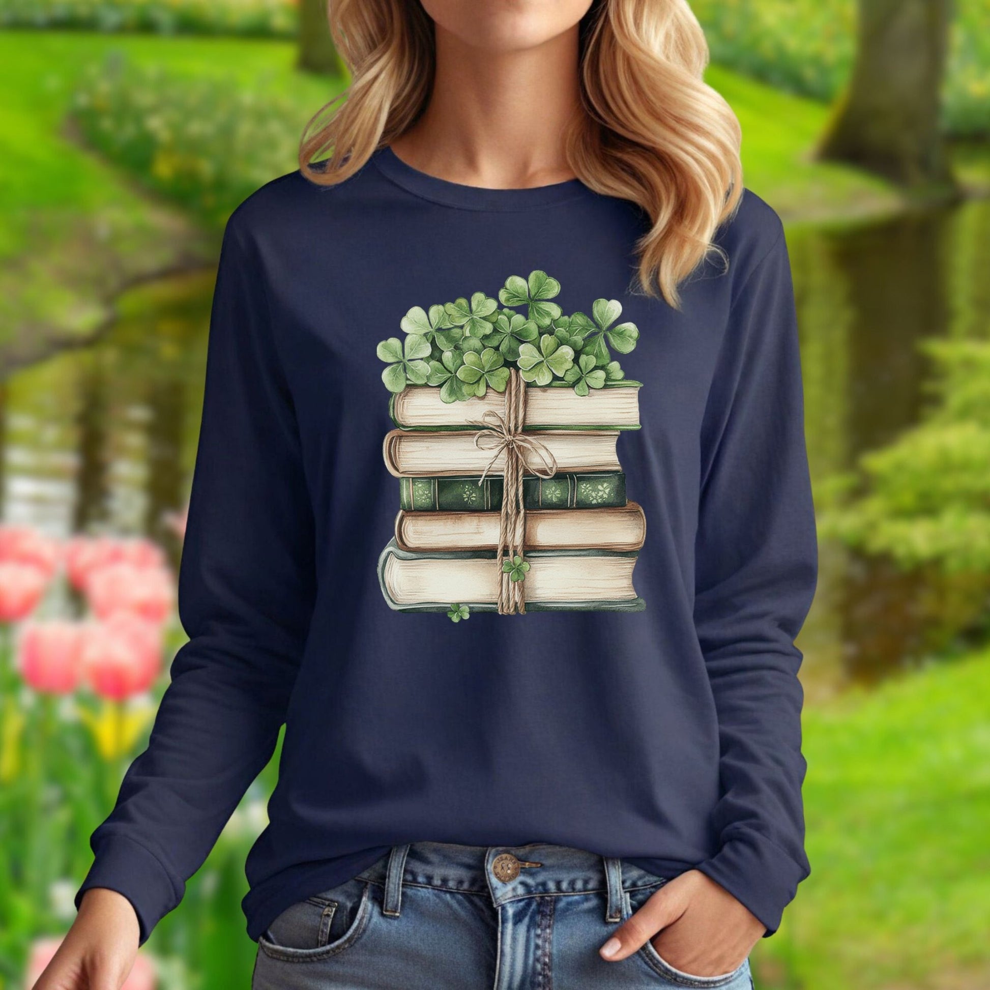 Navy long sleeve tee with watercolor vintage books tied with twine and four-leaf clovers.