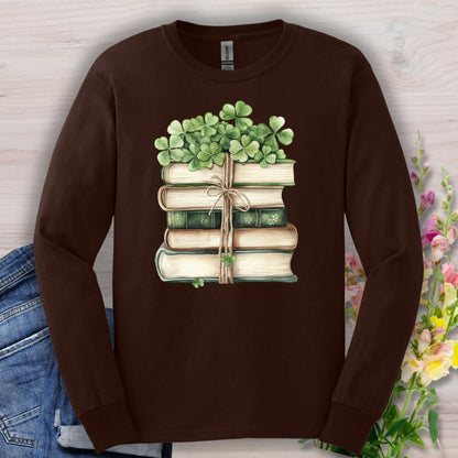 Dark chocolate long sleeve tee with a watercolor stack of vintage books and four-leaf clovers.