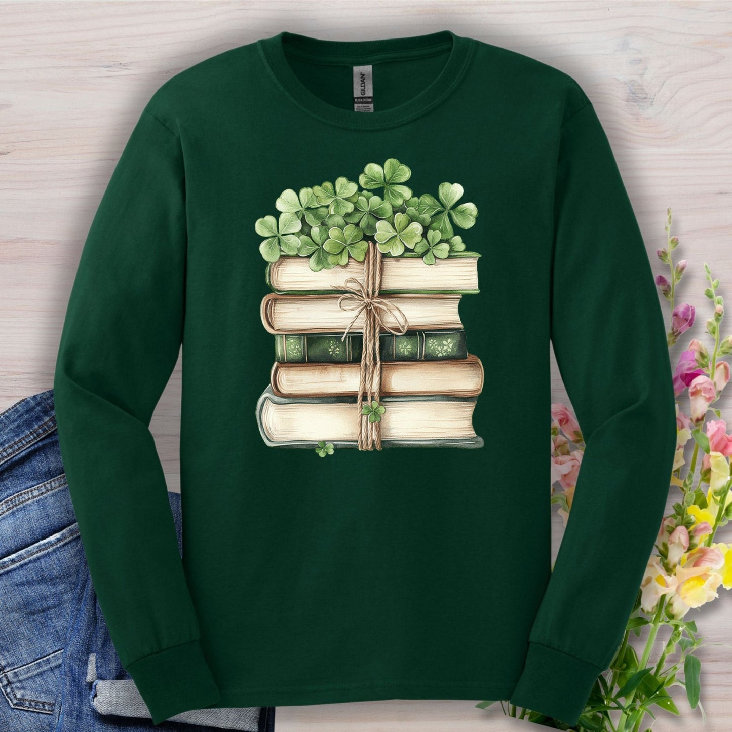 Forest Green long sleeve tee with a watercolor stack of vintage books tied with twine and clovers.