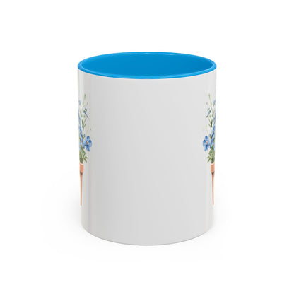White ceramic mug with blue interior and C-handle, featuring a watercolor terracotta pot with blue forget-me-nots.