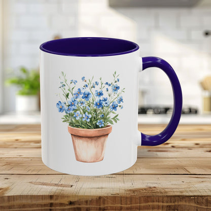 White ceramic mug with blue interior and handle, featuring a watercolor terracotta pot with blue forget-me-nots.