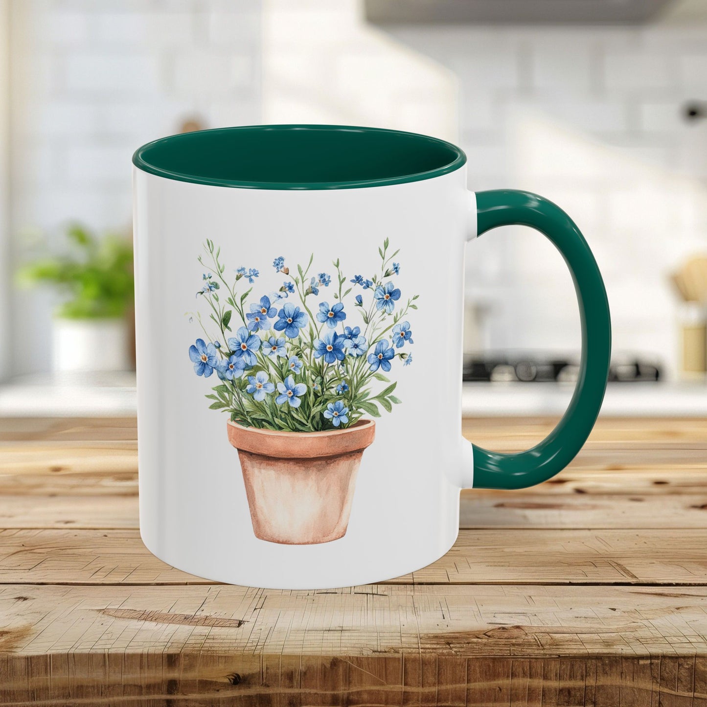 White 11oz ceramic mug with green handle/interior and watercolor terracotta pot with blue forget-me-nots.