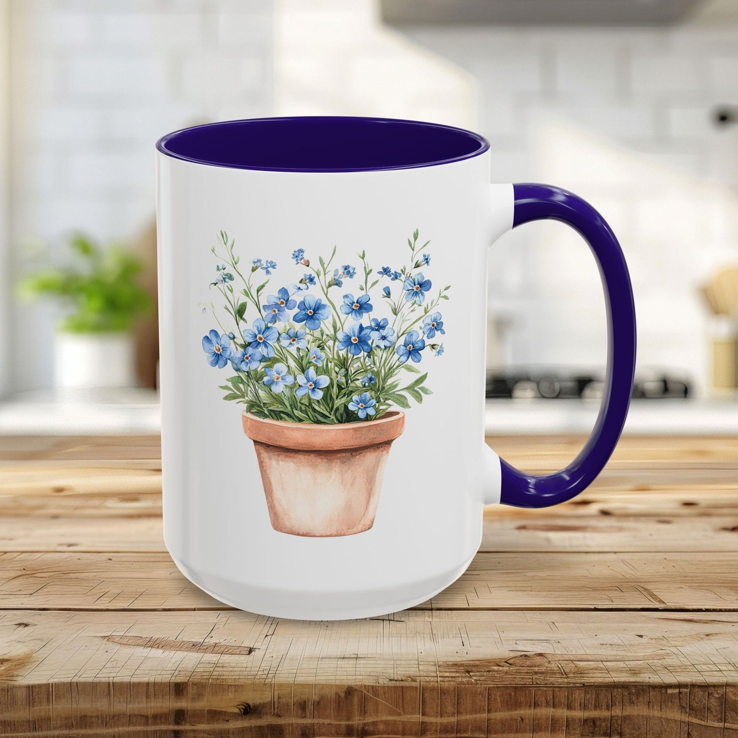 White 15oz ceramic mug with blue interior/handle, featuring a watercolor terracotta pot with blue forget-me-nots.