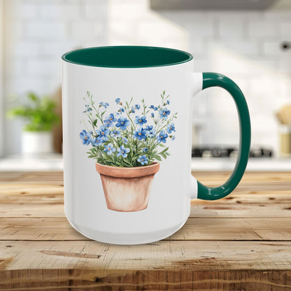 15oz white ceramic mug with green handle/interior, featuring a watercolor terracotta pot with blue forget-me-nots.