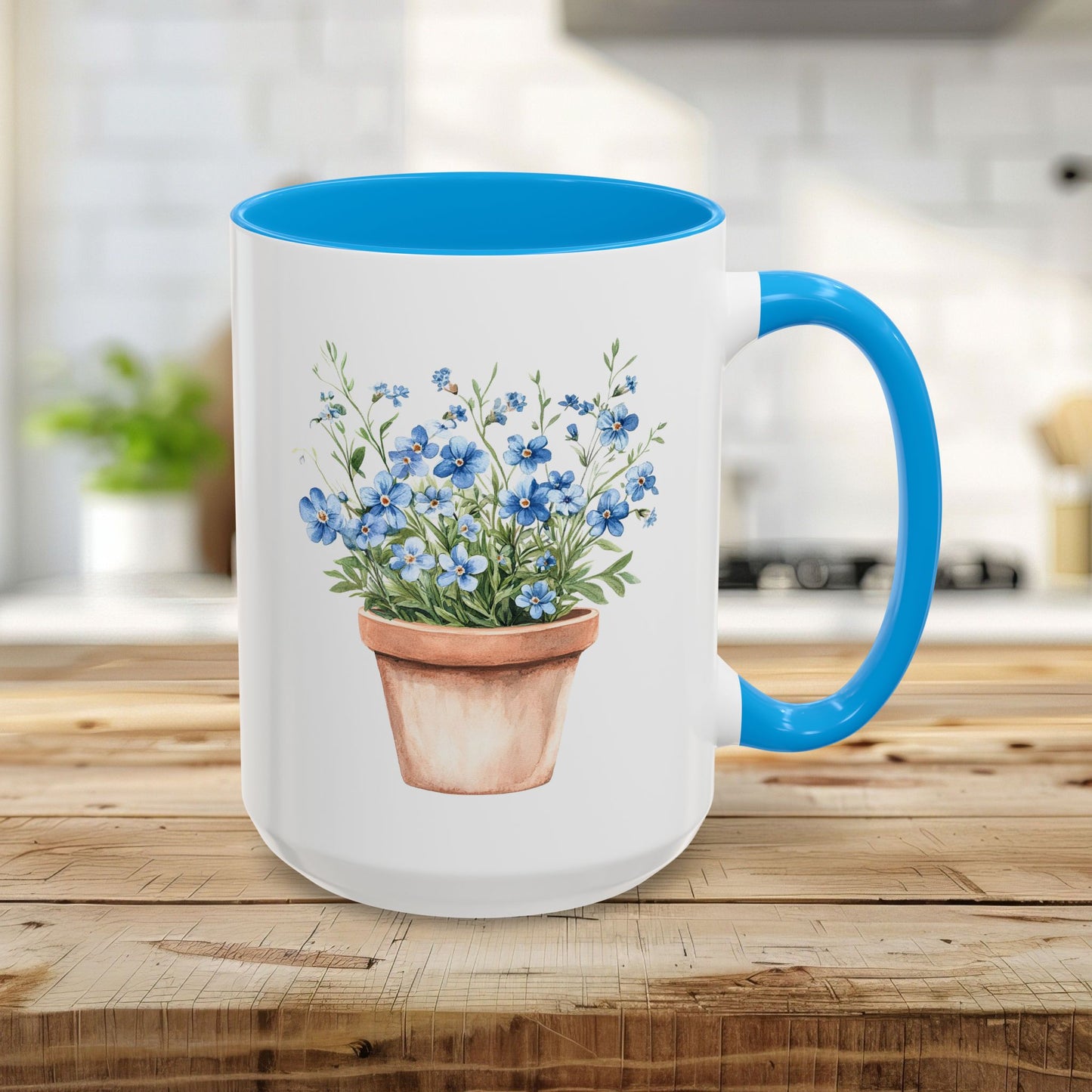 White 15oz ceramic mug with light blue handle/interior, featuring a watercolor terracotta pot with blue forget-me-nots.