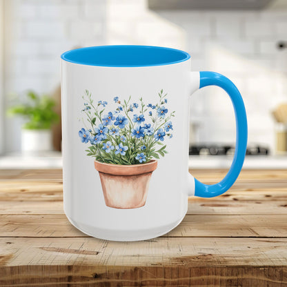 White 15oz ceramic mug with light blue handle/interior, featuring a watercolor terracotta pot with blue forget-me-nots.