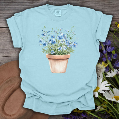 Chambray blue cotton t-shirt with a watercolor terracotta pot of blue forget-me-nots.