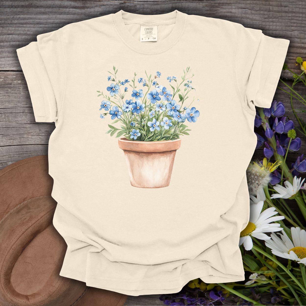 Ivory relaxed-fit t-shirt with a watercolor terracotta pot of blue forget-me-nots.