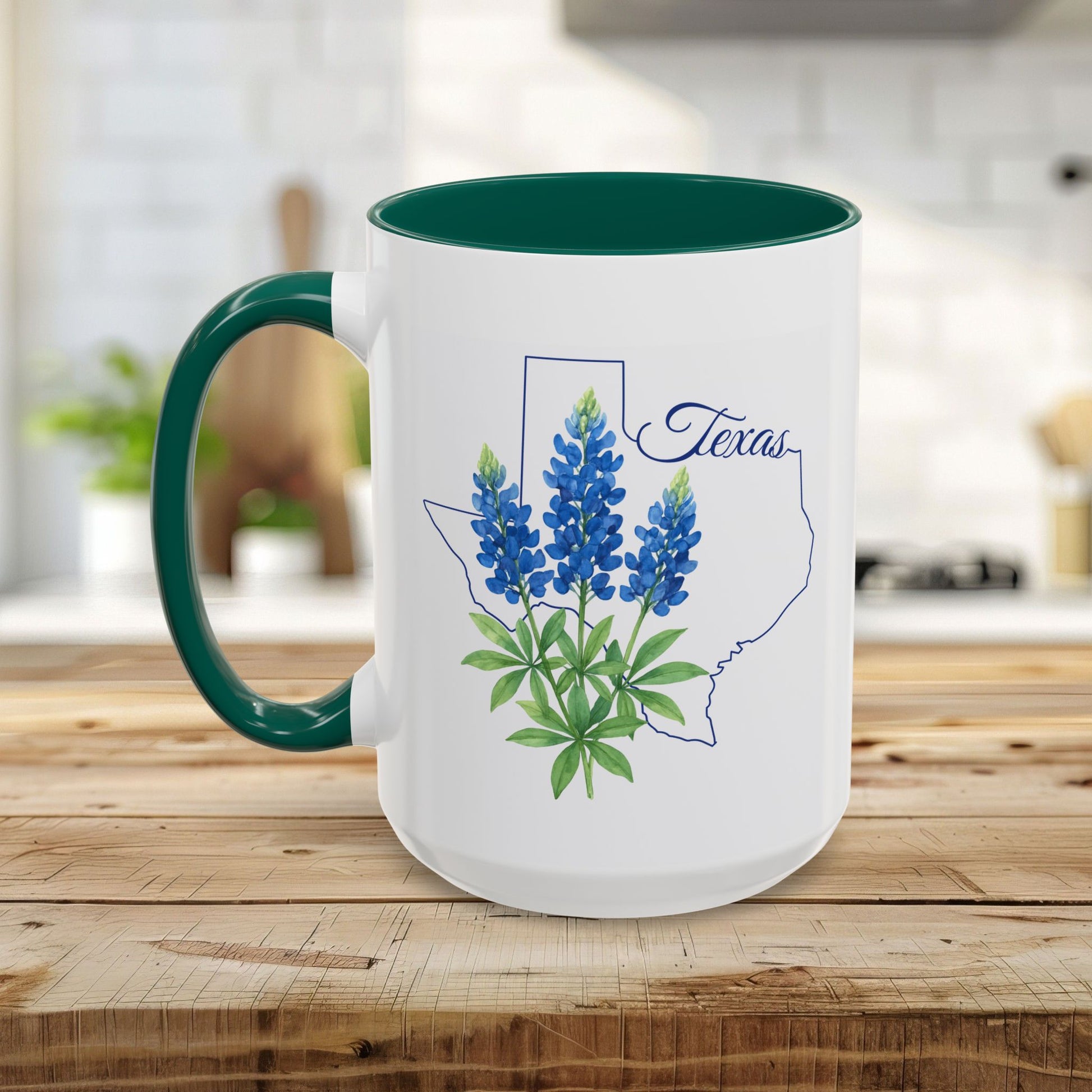 White ceramic mug with a green handle and interior, featuring bluebonnets inside a Texas outline.