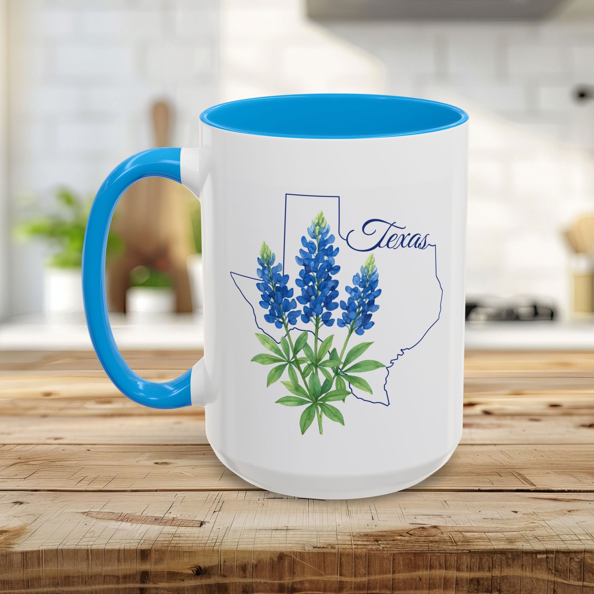 White ceramic mug with blue interior and handle, featuring a bluebonnet illustration inside a Texas outline.