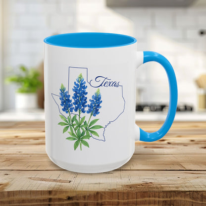 15oz glossy ceramic mug with a bluebonnet design inside a Texas outline, light blue interior and handle.