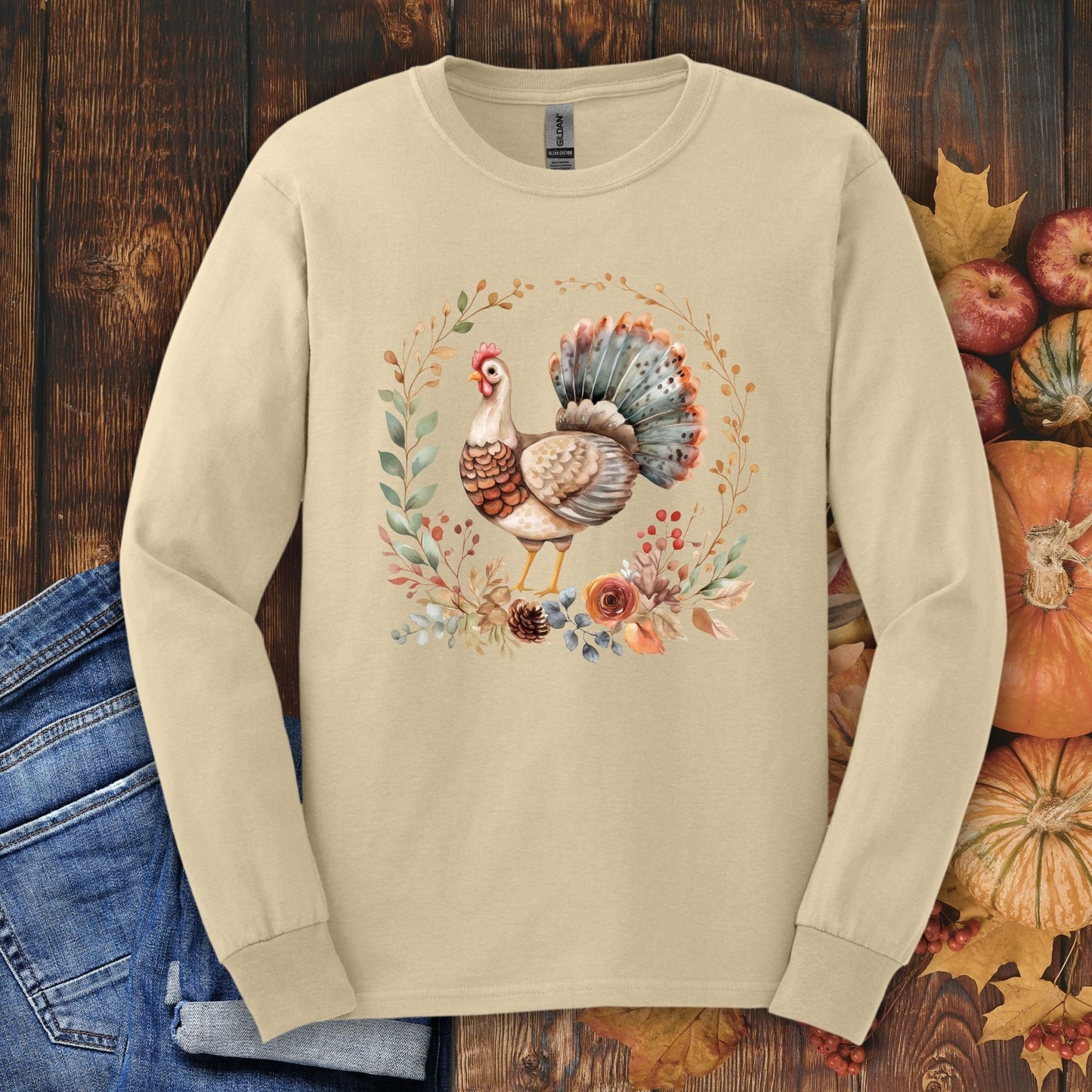 Sand long sleeve tee with a watercolor Thanksgiving turkey and autumn foliage design.