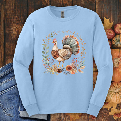 Light blue long sleeve tee with a watercolor Thanksgiving turkey and autumn foliage design.