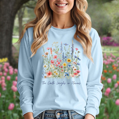 Light blue long-sleeve tee with watercolor wildflowers and "The Earth Laughs in Flowers" text.