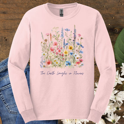 Light pink long-sleeve cotton tee with watercolor wildflowers and "The Earth Laughs in Flowers" text.