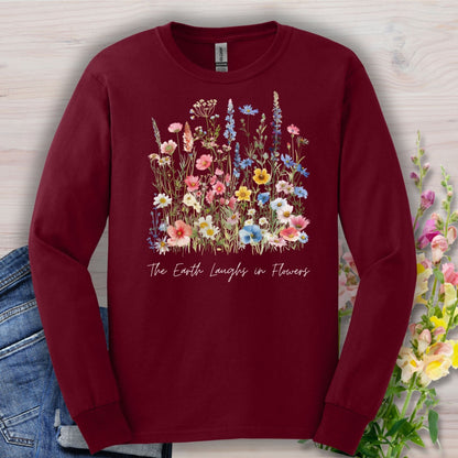 Maroon long-sleeve tee with a watercolor wildflower bouquet and "The Earth Laughs in Flowers" script.