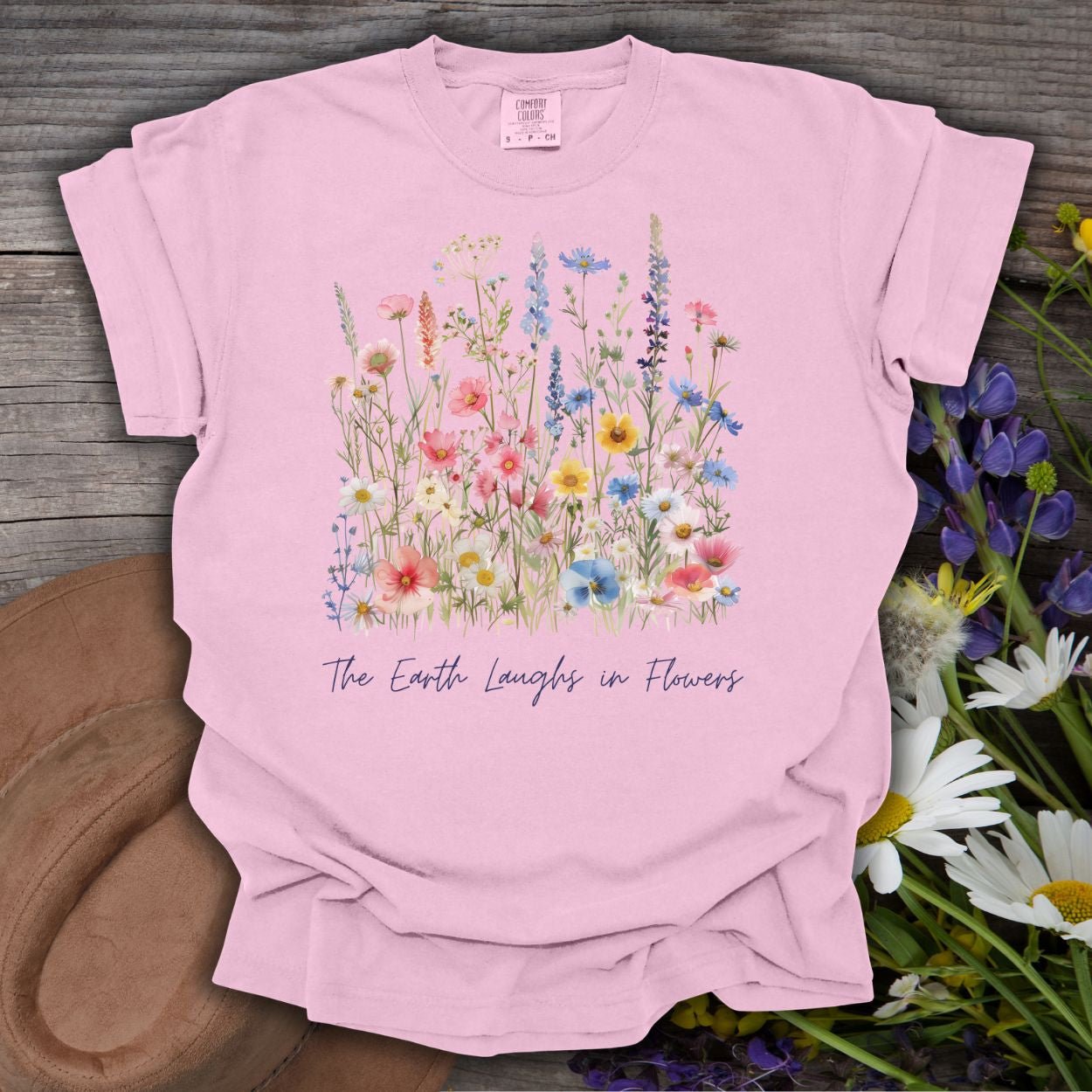Blossom pink garment-dyed cotton t-shirt with painterly wildflowers and "The Earth Laughs in Flowers" text.