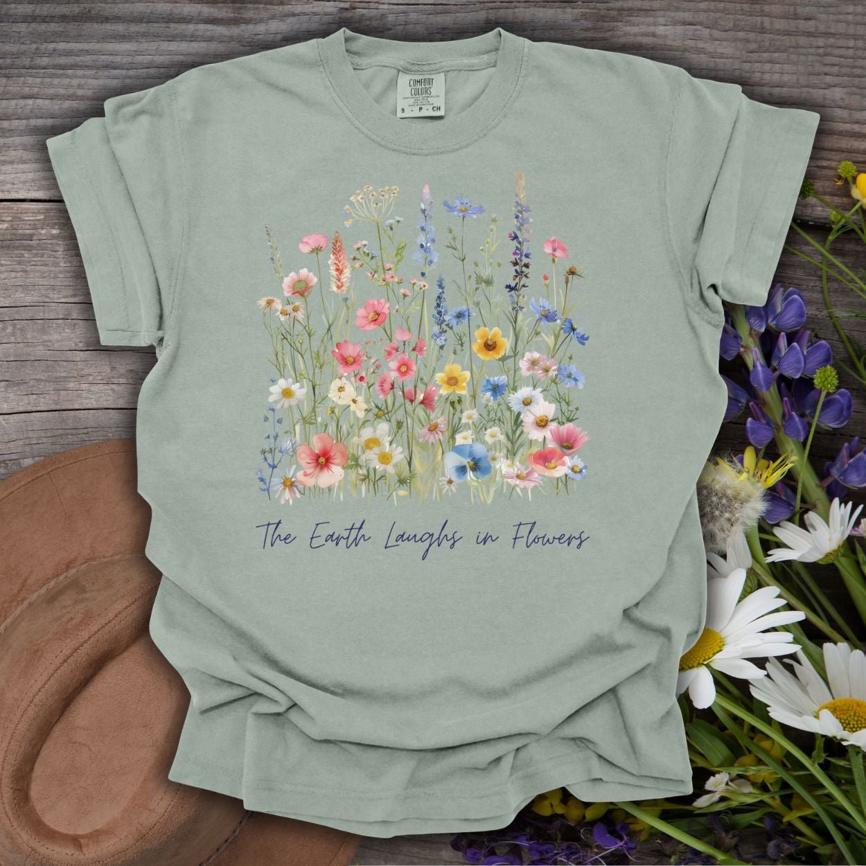 Garment-dyed Bay S cotton t-shirt with painterly wildflowers and "The Earth Laughs in Flowers" text.
