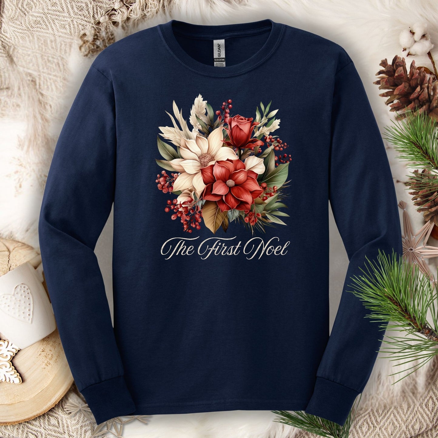 Navy Gildan long sleeve tee with a watercolor Christmas bouquet of poinsettias, roses, and "The First Noel" text.