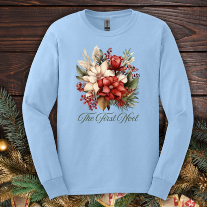 Light blue Gildan long sleeve tee with "The First Noel" and a watercolor Christmas bouquet of poinsettias, roses, and evergreen.