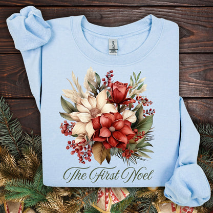 Light blue Gildan sweatshirt with vintage poinsettia, rose, and foliage bouquet, "The First Noel" text.