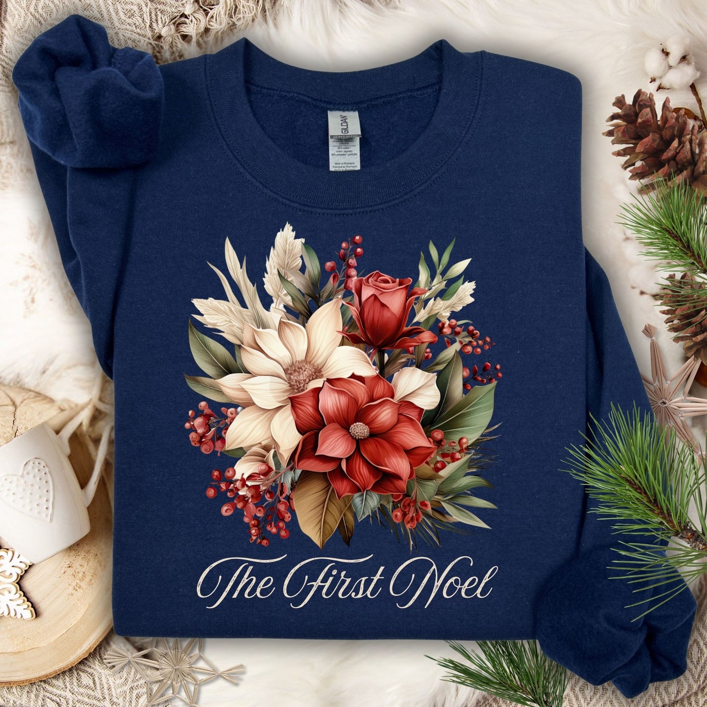 Navy Gildan sweatshirt with vintage poinsettia, rose, and foliage bouquet, "The First Noel" text.
