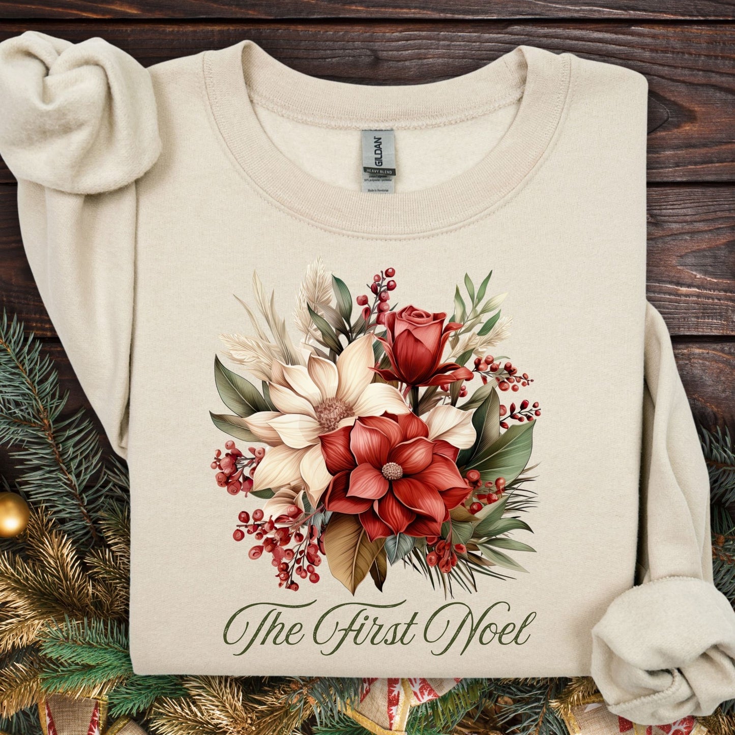 Sand Gildan sweatshirt with vintage poinsettia, rose, and foliage bouquet, "The First Noel" text.