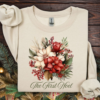 Sand Gildan sweatshirt with vintage poinsettia, rose, and foliage bouquet, "The First Noel" text.