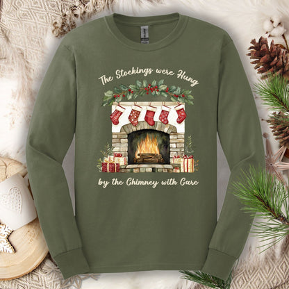 Military Green S long sleeve tee with watercolor fireplace, red stockings, holly, and Christmas poem text.