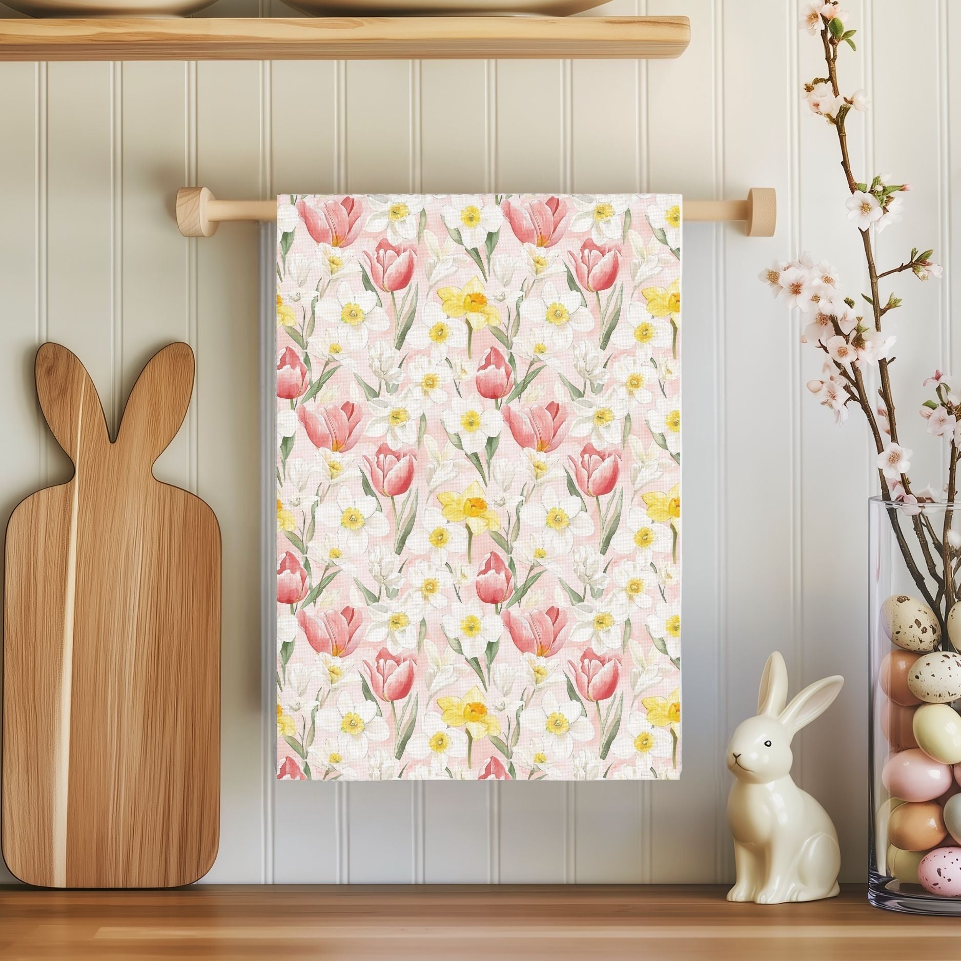 Microfiber tea towel with watercolor pink tulips and yellow daffodils, hanging in a cozy kitchen.
